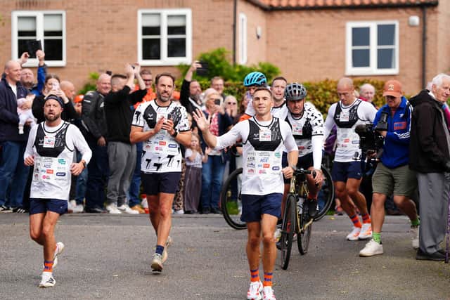 Sir Kevin Sinfield (centre) is joined by Sir Gareth Southgate as he arrives at Shiptonthorpe Village Hall at the end of day one of the 7 in 7: The Grand Finale 2026 Challenge