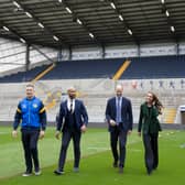 The Prince and Princess of Wales, walk with Jamie Jones Buchanan, CEO of the Leeds Rhinos and a lifelong friend of Rob Burrow, during a visit to the Leeds Rhinos at the AMT Headingley Rugby Stadium
