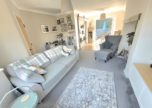 A bay-fronted living room brings natural light into the main reception space and creates a welcoming place to relax