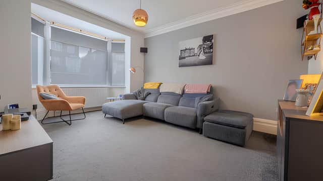 The ground-floor living room provides a welcoming space for relaxing and entertaining within the property's flexible family layout