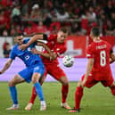 FINE RUN: Extended by Leeds United defender Nico Elvedi, centre, for Switzerland, pictured in action against Slovenia.