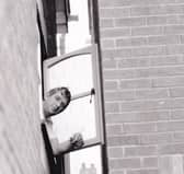 John Cook tries to open his landing window.