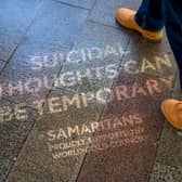 The quotes were made using reverse graffiti, and appear on pavements across London