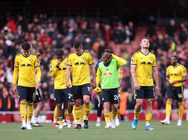 ONE THAT GOT AWAY: As Leeds United's players show their disappointment at Arsenal.