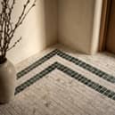 ROMAN LUXURY Lapicida’s Calacatta Gold Marble Mosaic creates an elegant statement floor with contrasting Verde Guatemala detailing.
