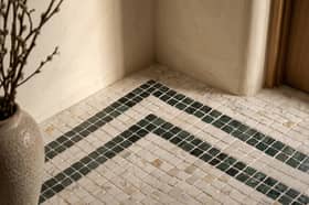 ROMAN LUXURY Lapicida’s Calacatta Gold Marble Mosaic creates an elegant statement floor with contrasting Verde Guatemala detailing.