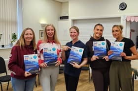  Helen Underwood with learners from a recent Paediatric First Aid course holding the newly printed fifth edition of The ABCDE of First Aid