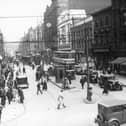 Trams at the junction of Boar Lane and Briggate in Leeds city centre