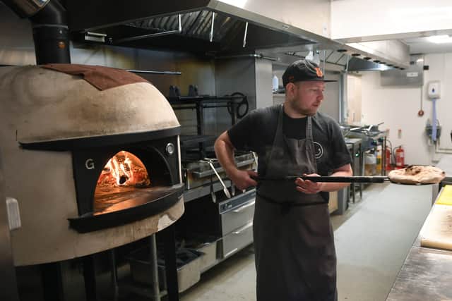 Head chef of Galleria Andy Castle cooking a flatbread in the kitchen