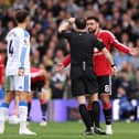 Referee Darren England tried to let pay go at Elland Road on Sunday.