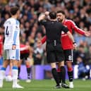 Referee Darren England tried to let pay go at Elland Road on Sunday.