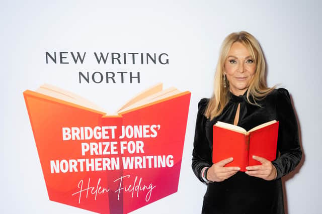 Morley-born author Helen Fielding holding an open book at the launch of the Bridget Jones Prize for Northern Comedy Writing in partnership with New Writing North