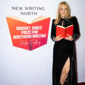 Morley-born author Helen Fielding holding an open book at the launch of the Bridget Jones Prize for Northern Comedy Writing in partnership with New Writing North