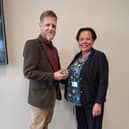 Liz's husband Rob Keat accepting the award from Michelle Bateman, Deputy Chief Nursing Officer for England