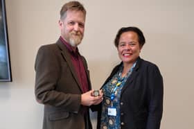 Liz's husband Rob Keat accepting the award from Michelle Bateman, Deputy Chief Nursing Officer for England