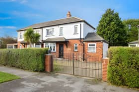 Gated double iron gates open onto a driveway with space for up to four cars at this refurbished Broadway home.