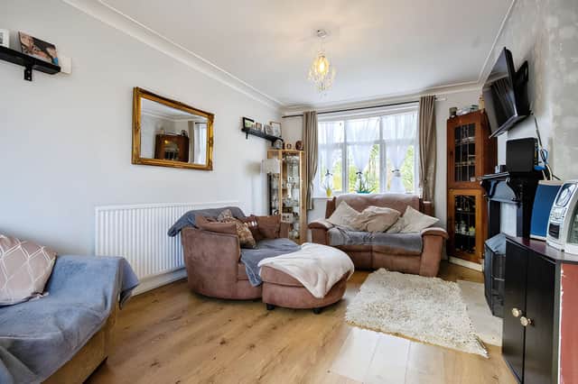 A bay window brings natural light into the spacious living room, one of the home's main reception spaces.