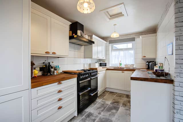 The brand-new kitchen connects with the dining room, creating a practical space for family meals and entertaining.