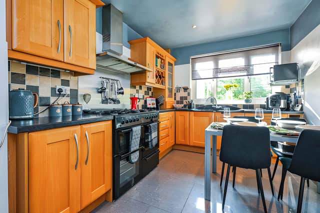 The contemporary fitted kitchen combines modern finishes with a practical layout, complemented by a separate utility room.