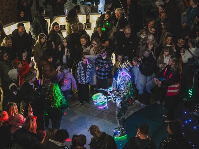An LED drummer performs for crowds inside The Light in Leeds city centre during the 'Light Up The Light' event for Leeds Light Night 2026
