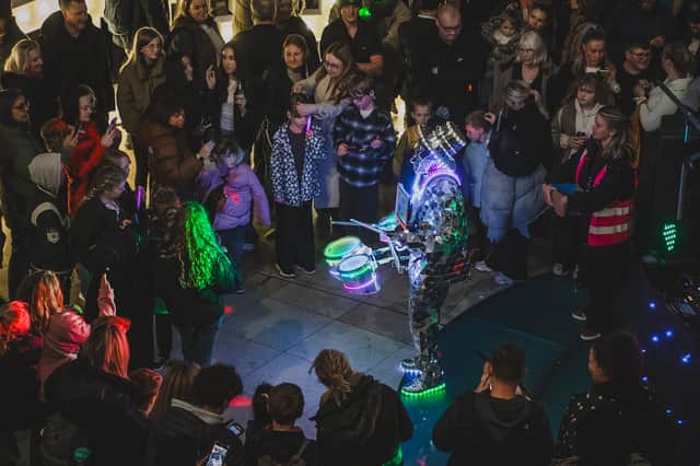 An LED drummer performs for crowds inside The Light in Leeds city centre during the 'Light Up The Light' event for Leeds Light Night 2026