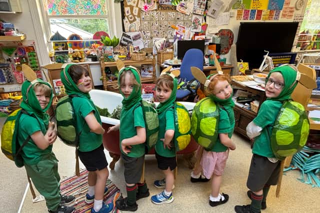 Moorfield pupils bring Alice in Wonderland to life in handmade papier-mâché turtle costumes 