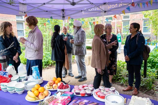 Group photo of guests enjoying refreshments at the Volunteers’ Week garden party.