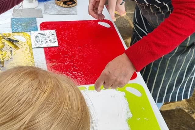 Print artist, Kay Taylor, runs a workshop outside her home for the festival