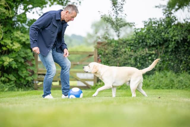 Stuart having a kick around with hearing dog Jinx