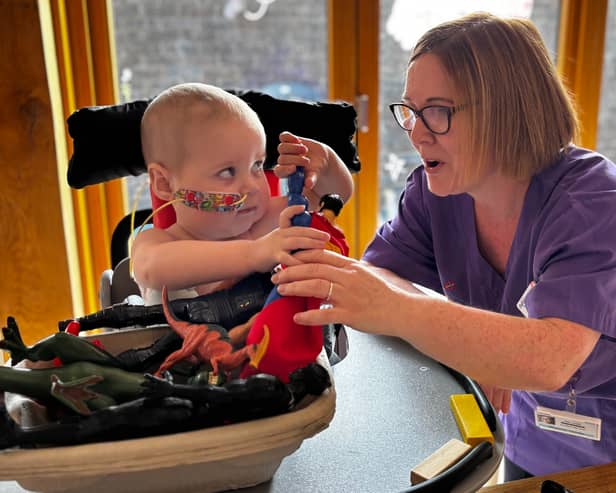 Robin interacting with a Play Specialist in hospital