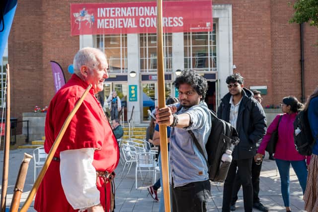 Visitors try their hand at traditional archery.