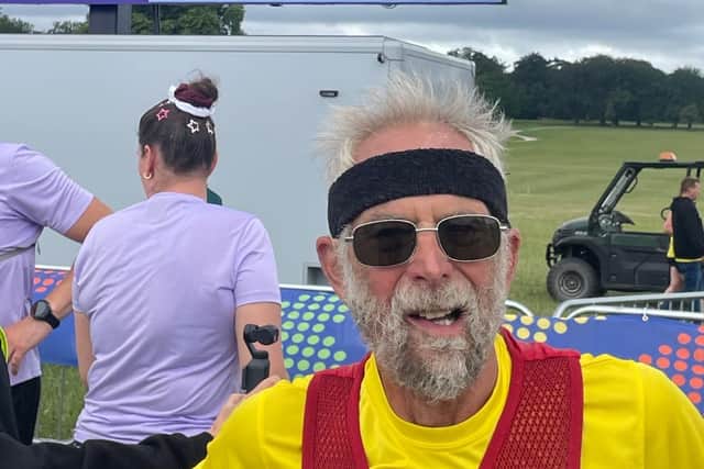 Mike at the end of his challenge with his completed laps behind him