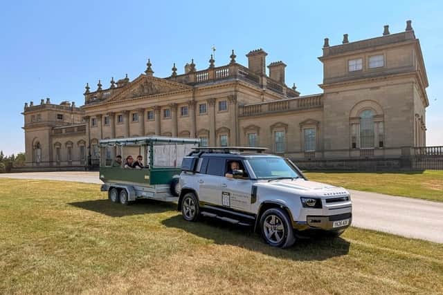 John Steele in the driver's seat with some of the team from Harewood House