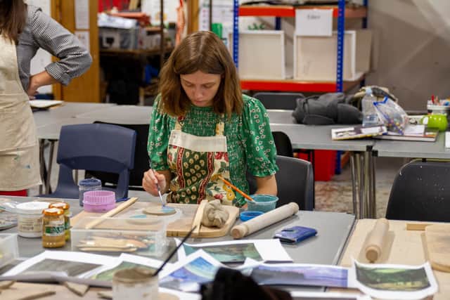 Pyramid artist works on ceramic tiles for an exhibition at Leeds Art Gallery.