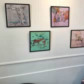 Artist Doll with artwork from their 'Take a Load Off' exhibition