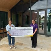 Louise presenting a cheque for £2,525 to Jessica Harrison from Leeds Hospitals Charity.
