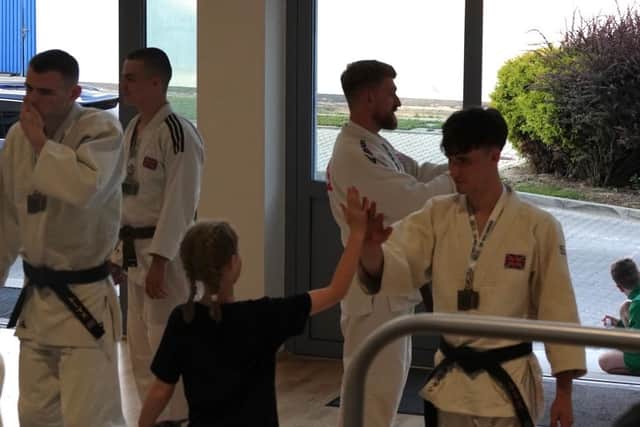 Ethan David receives congratulations from younger members of the Great Britain squad.