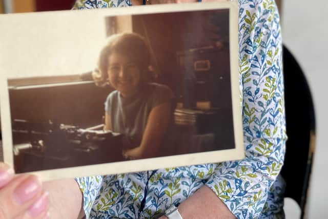 Denise holding a picture of her at 18-years of age when she first started working for Leeds Hospitals