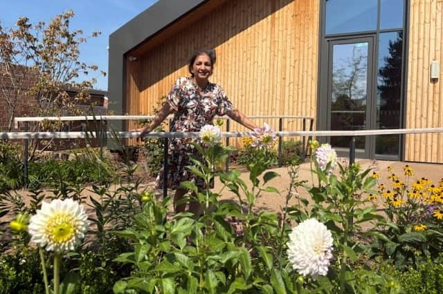 Dr Agam Jung with the dahlias in the garden of the Rob Burrow Centre for MND