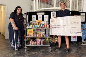 Community Pantry Chair Olivia Rowley receives the donation from Taylor Wimpey’s Tarnya Chadwick.