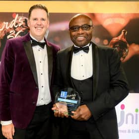 Cedric Boston (right), Unity Homes and Enterprise Chief Executive, receives the Housing Executive Award for Best Social Value Project from Paul Smith, Head of Frameworx at NHMF Frameworx.