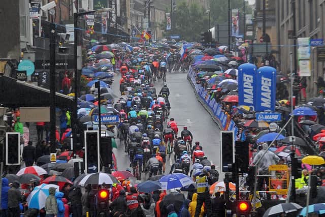 29 September 2019......    Spectators watch the Men's Elite road race  in heavy rain in Harrogate.