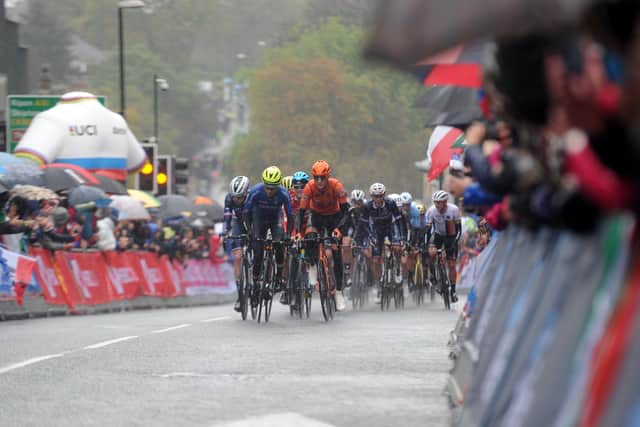 Spectators watch in the pouring rain