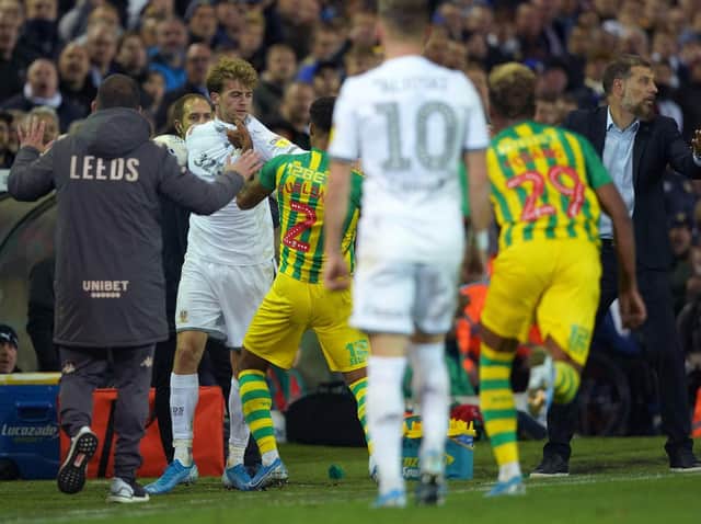 Leeds United's Patrick Bamford clashes with West Brom players at Elland Road.