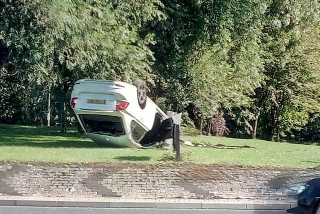 Overturned car on Dewsbury Road, next to the White Rose Shopping Centre in Leeds