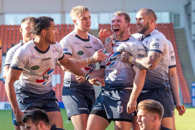 Featherstone Rovers players celebrate Bradley Day's try against York.