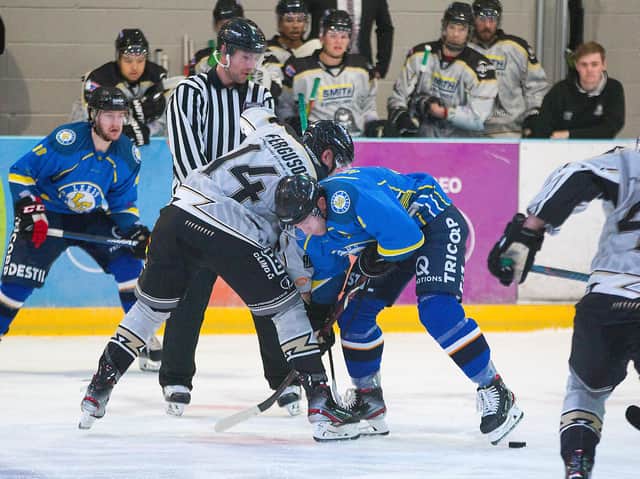 BATTLE LEVEL: James Archer battles for puck possession at the face-off in Milton Keynes last Saturday. Picture courtesy of Tony Sargent.