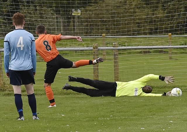 Josh Wilson of Wetherby Athletic beats Aberford goalkeeper Anthony Haywood from the penalty spot.