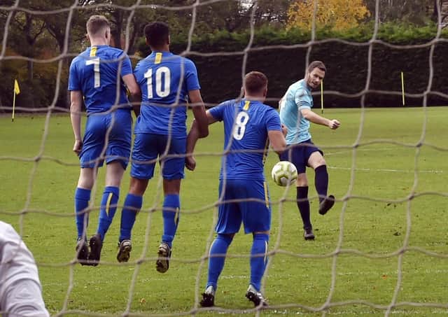 Craig Farrand of Farsley Celtic Juniors fires a free-kick at the Calverley United wall. Picture: Steve Riding.