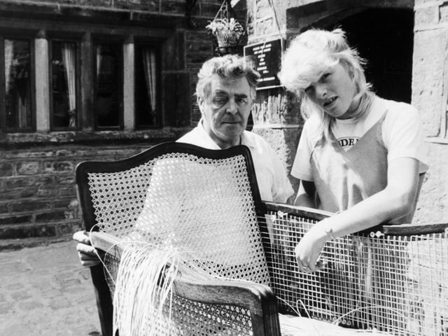 Booth's Yard Antiques at Lowtown. Harry Fowler and his granddaughter, Tracey at work on a bergere cane chair.